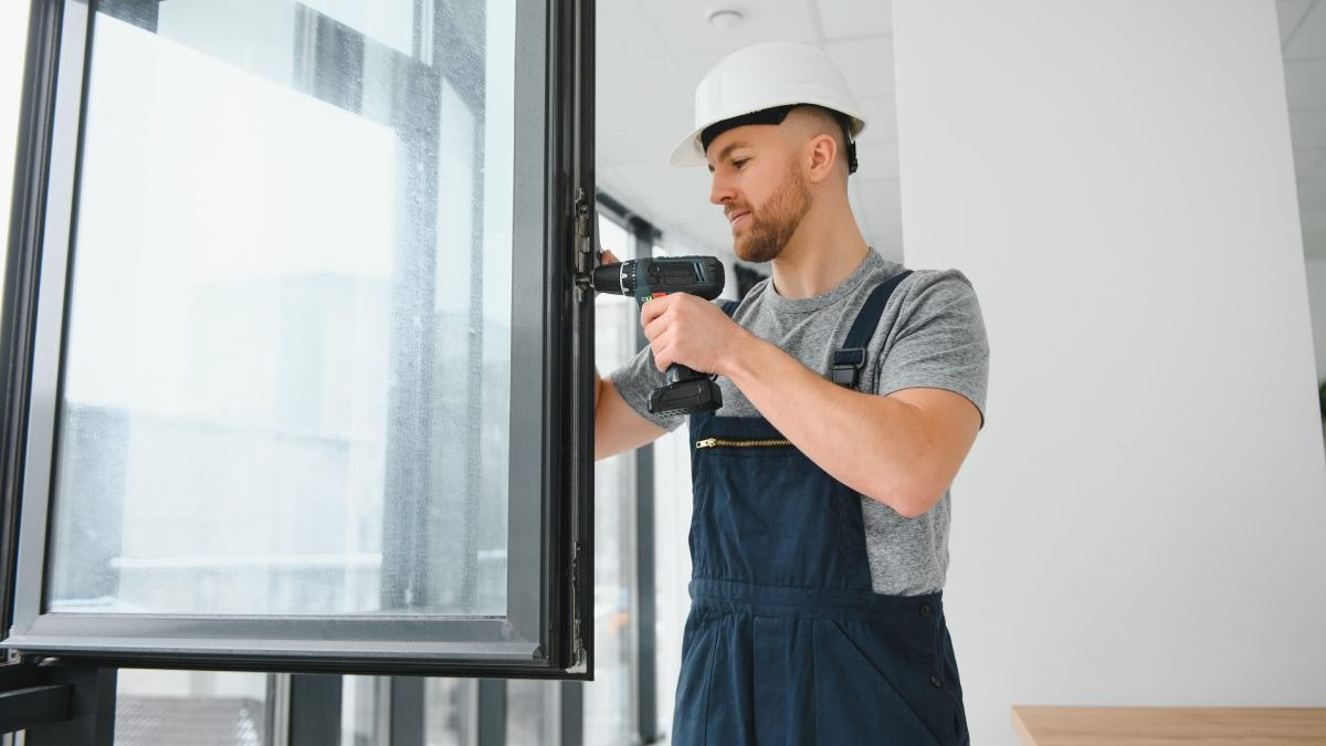 construction-worker-repairing-plastic-window-with-screwdriver-indoors-space-text-banner-design-1-scaled-1.jpg