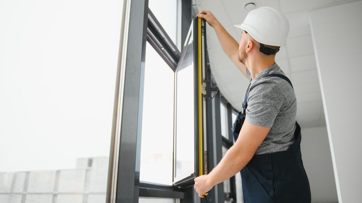 construction-worker-repairing-plastic-window-with-screwdriver-indoors-space-text-banner-design-5-scaled-1.jpg